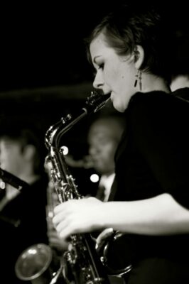 Black and white image of a woman playing a saxophone