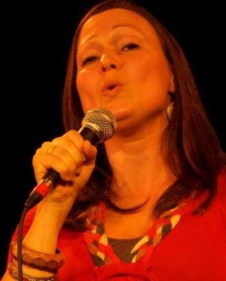 Close up of a woman singing into a microphone