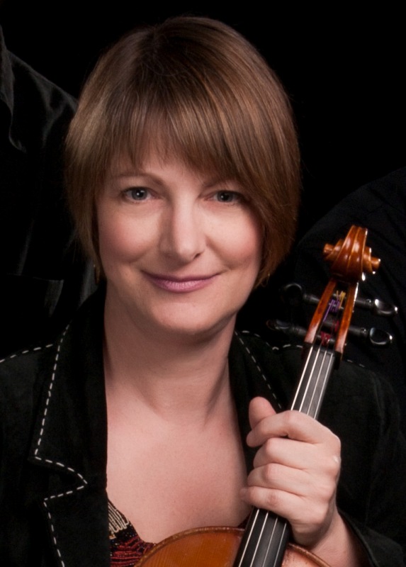 Closeup of a woman holding a violin by the neck